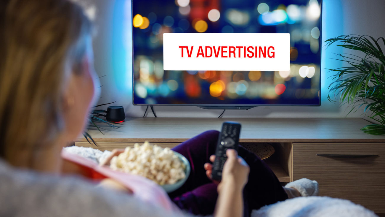 Concept,Of,Advertising,On,Television,,Woman,Looking,At,Ad,While
